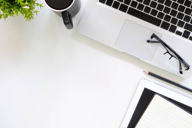 istock Copy space of workspace with office supplies top view table. 1034976580