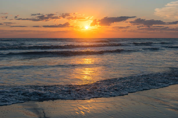 istock Bright colorful sunrise on the seashore 1034981486