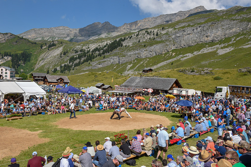 Engstlenalp, Switzerland - 4 August 2018: Two Swiss taking part in a traditional wrestling match (called 'Schwingen') at Engstlenalp on the Swiss alps