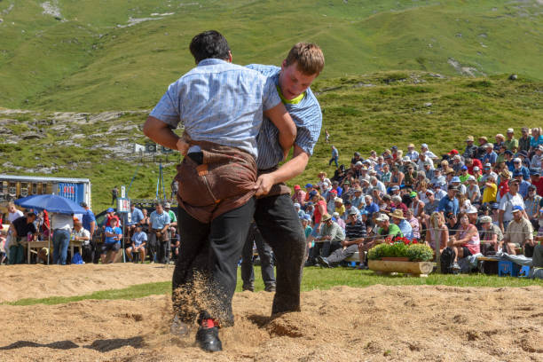 Engstlenalp, Switzerland - 4 August 2018: Two Swiss taking part in a traditional wrestling match (called 'Schwingen') at Engstlenalp on the Swiss alps