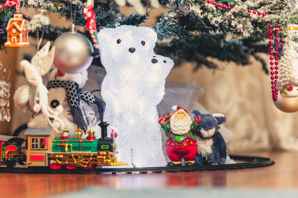 istock Figure of polar bear with bear cub under Christmas tree 1034998378