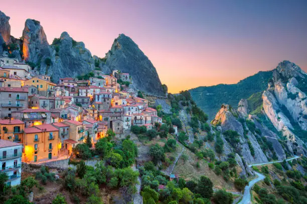 Cityscape aerial image of medieval city of Castelmazzano, Italy during beautiful sunrise.