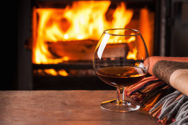 istock a glass of cognac in front of fireplace 1035007220