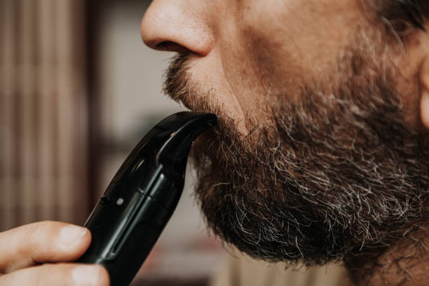 istock Cutting  mustache with black trimmer close-up 1035007896