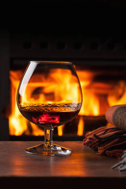 istock a glass of cognac in front of fireplace 1035007908