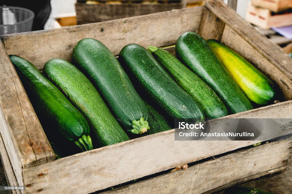 Zucchinis in wooden box at the market Zucchini Stock Photo