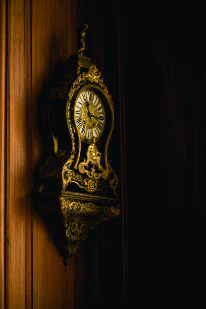 istock Old antique clock hanging on a wooden wall 1035008454