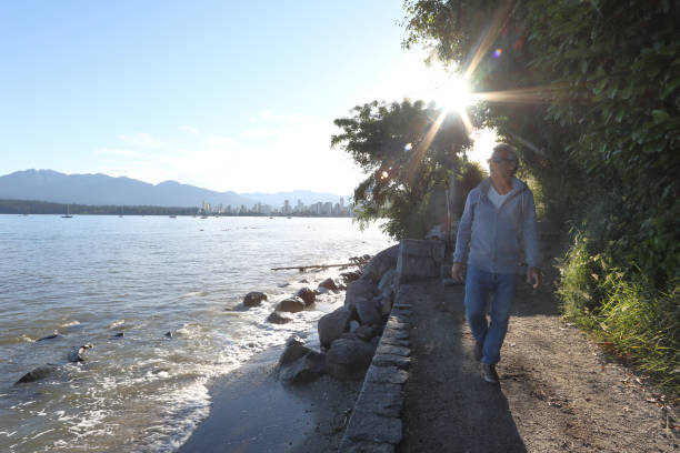 istock Man walks along path by the water 1035011308