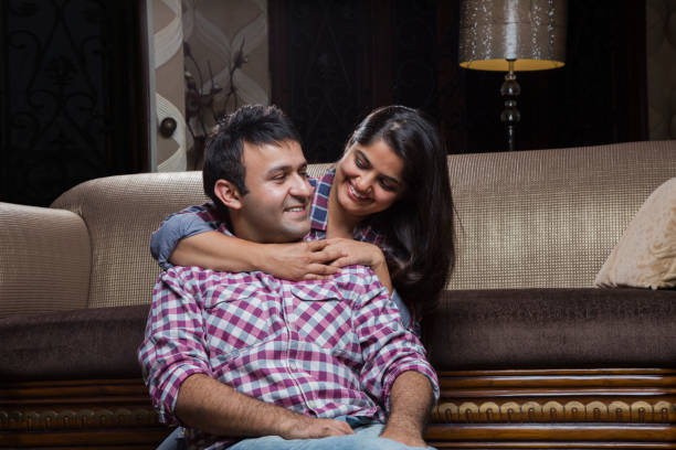 istock Young beautiful couple chatting on sofa - Stock image 1035011754