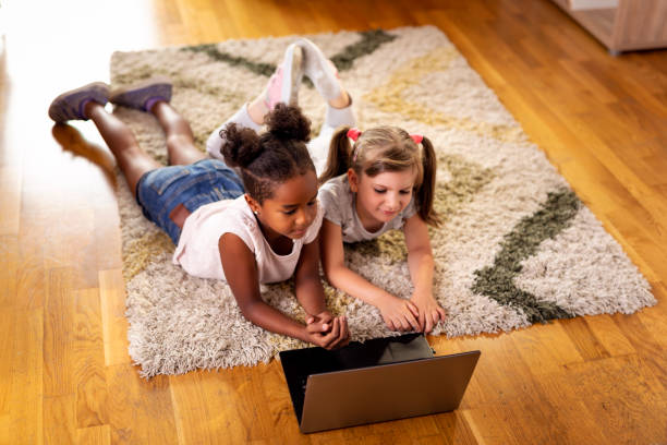 istock Little girls watching cartoons on a laptop computer 1035020730