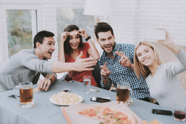 istock Young Smiling People Have Fun on Party at Home. 1035025422
