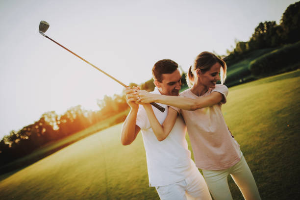 istock Young Happy Couple Playing Golf on Field in Summer 1035026756