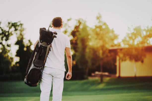 istock Young Man in White Clothes Playing Golf on Field. 1035026808
