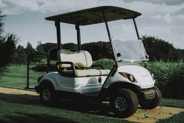 istock White Little Cart on Golf Field in Sunny Day. 1035026818