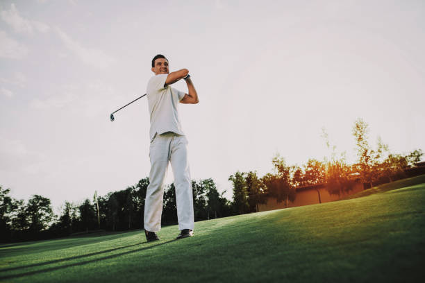 istock Young Man in White Clothes Playing Golf on Field. 1035026824