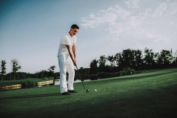 istock Young Man in White Clothes Playing Golf on Field. 1035026846
