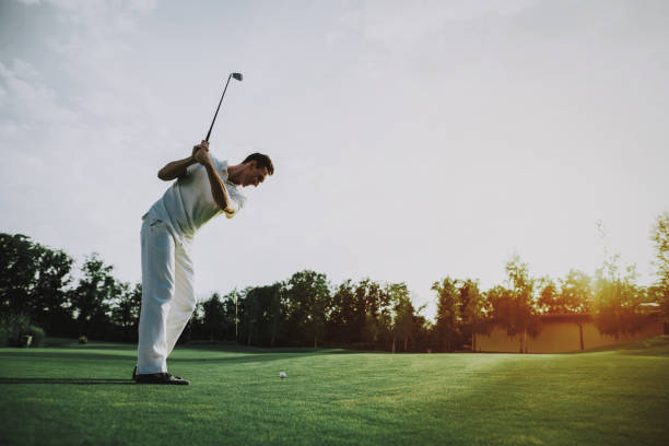 istock Young Man in White Clothes Playing Golf on Field. 1035026878