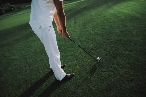 istock Young Man in White Clothes Playing Golf on Field. 1035027046