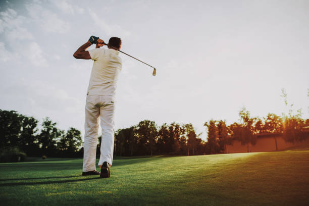 istock Young Man in White Clothes Playing Golf on Field. 1035027092