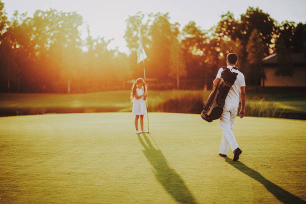 istock Father Playing Golf with Little Daughter on Field. 1035027148