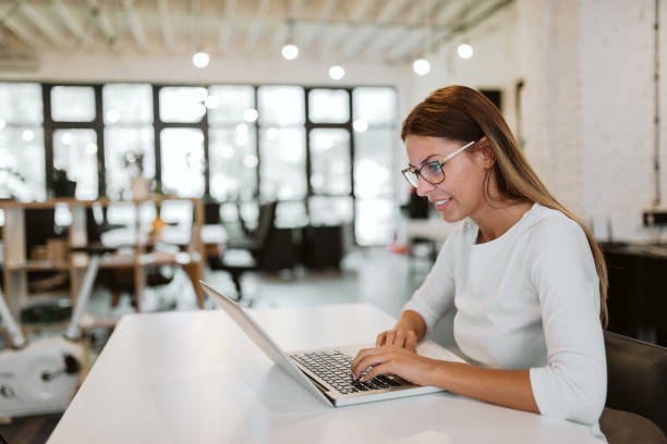 istock Young woman working on laptop in bright creative studio. 1035038712