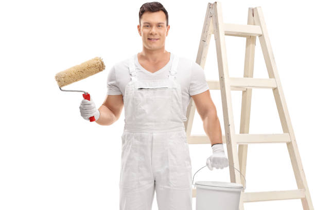 istock Painter with a paint roller, a color bucket and a ladder 1035040900