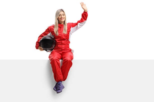 istock Female racer sitting on a panel and waving 1035043196