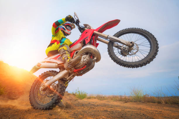 istock Motocross rider doing a wheelie 1035048596