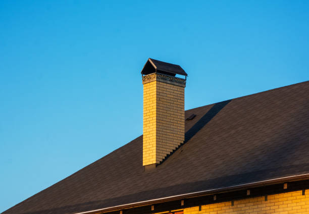 istock Modern brick chimney with beautiful forge. Clear blue sky background 1035049946