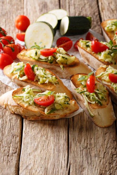 istock Bruschetta with grated zucchini and tomatoes close-up and ingredients. vertical 1035052182