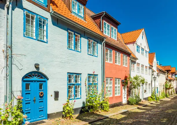 Photo of View of a typical german-danish street with colored houses. Traditional architecture style. Flensburg, Germany