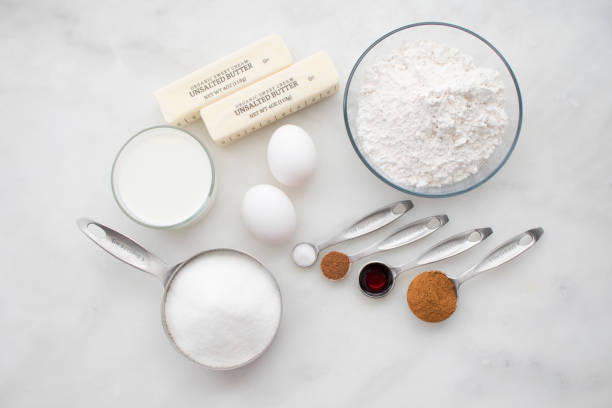 cinnamon sugar muffin ingredients - measuring cup imagens e fotografias de stock