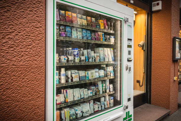 self service pharmaceutical distributor In front of a downtown pharmacy Milan, Italy - November 5, 2017: in front of a pharmacy, an automatic vending machine selling pharmacy products on a fall day medicine vending machines stock pictures, royalty-free photos & images