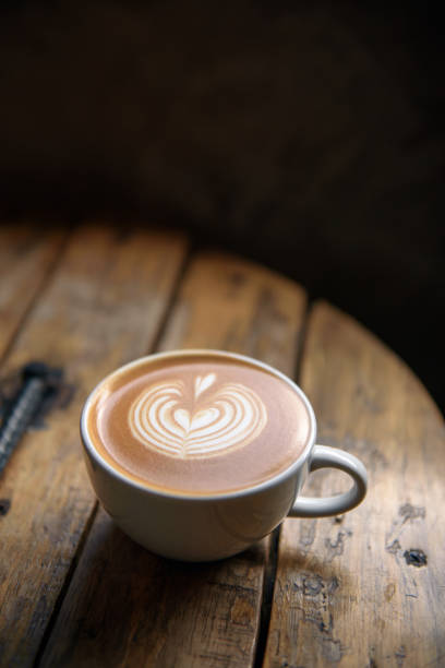istock A cup of latte on wooden table 1035059282