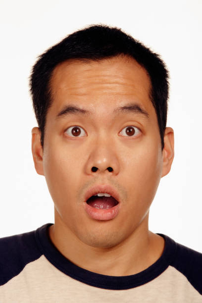 istock Close up studio shot of Asian man looking surprised 1035059340