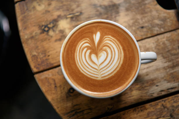 istock A cup of latte on wooden table 1035059440