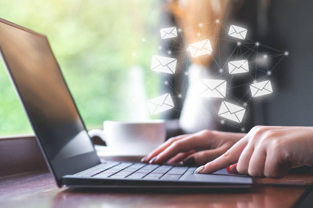 Businesswoman using laptop to send e-mail. Social media concept