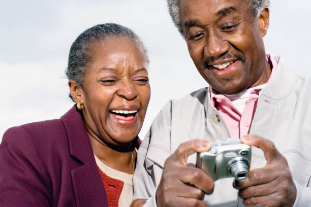 istock Senior African couple smiling and looking at digital camera 1035073328
