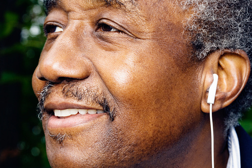 Close up of senior African man with earbud