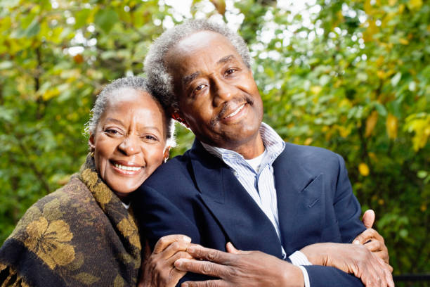loving senior african couple looking one another over white background
