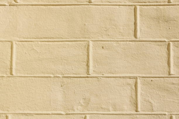 istock faded natural yellow background with brick texture 1035074004