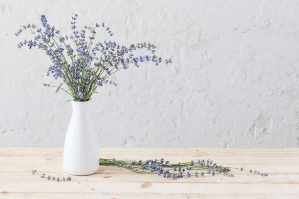 istock lavender in white vase on wooden table 1035074058