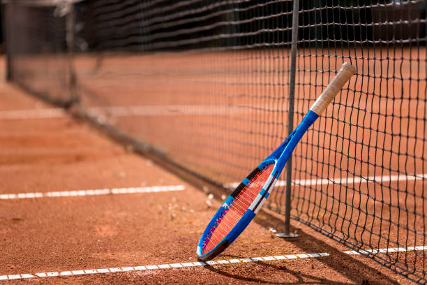 istock Tennis racket by the net 1035076770