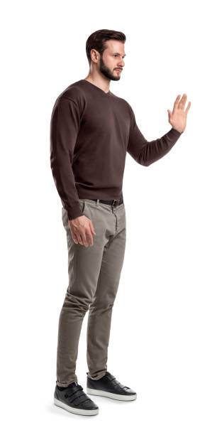 istock A young bearded man in a side view stands with one hand up and held palm to the front. 1035077572