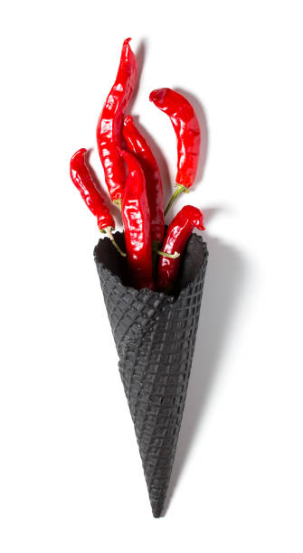 istock Red chili pepper symbolizing torch with fire on White isolated background. Hot pepper in a black Ice cream cone 1035080918