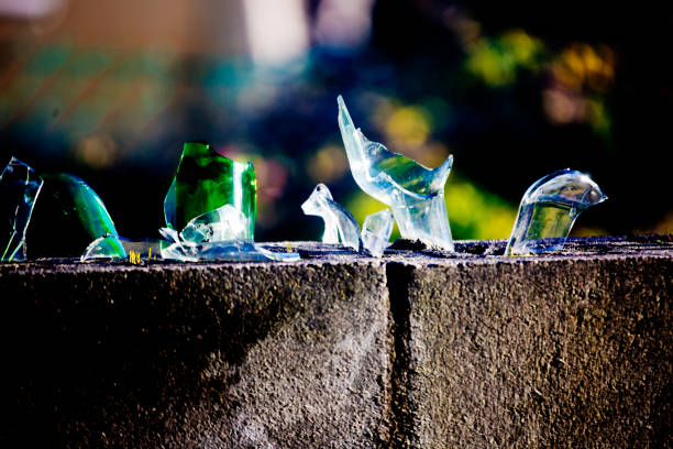 istock Sharp broken glass pieces on top of a brick wall 1035088354