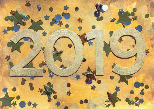 istock 2019 on gold background with stars and confetti 1035088498