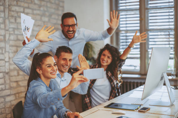 istock Group of young people doing selfie in the office 1035088636