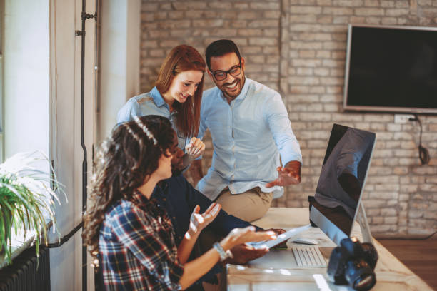 istock Young group of designers negotiates about design 1035089716