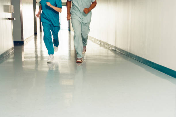 Two nurses running down corridor in hospital